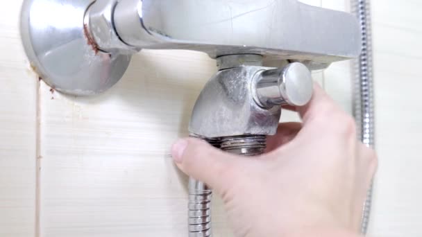 Bathtub faucet reparing, tightening the nut on a new hose instead of leaky shower hose, plumbing repairs and DIY concept — Stock Video