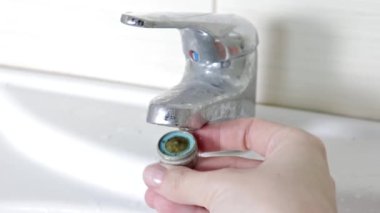 Kadın tamirciyle Değiştir aerator dokunun, elinde bir tesisatçı yakın çekim