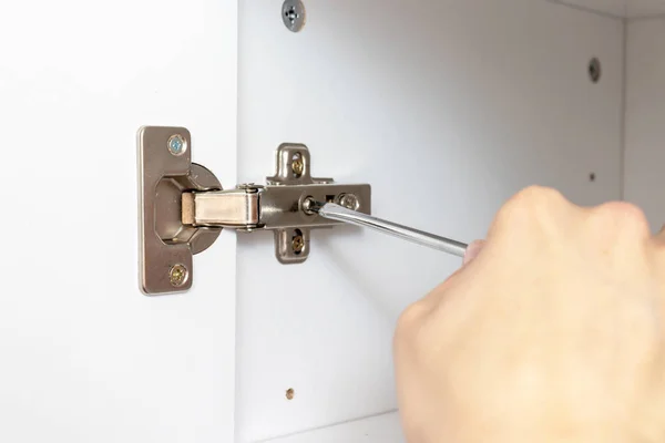 Ajuste de puertas de muebles utilizando un destornillador, ensamblando el concepto de muebles — Foto de Stock