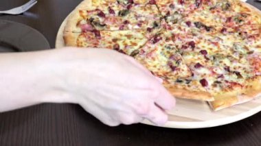 Plaka üzerine koyarak masaya oturan ve bir parça lezzetli pizza, çekici kadın