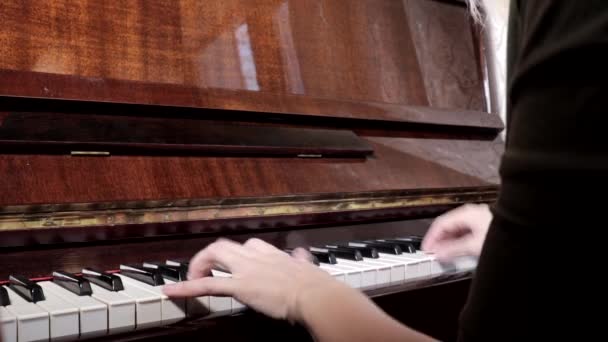 Manos de mujer caucásica tocando el piano, de cerca, vista lateral — Vídeo de stock