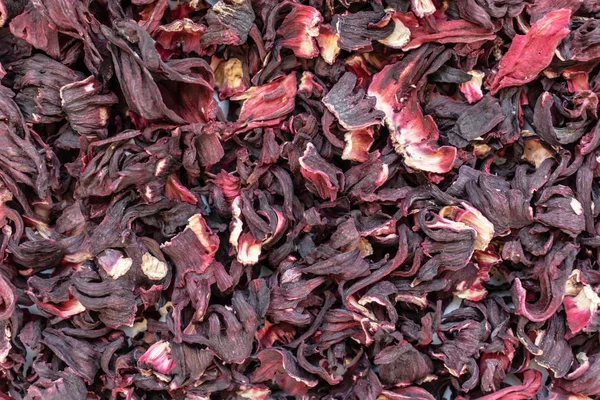 Dry hibiscus flowers tea texture background from Sudanese rose, karkade