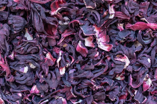 Dry hibiscus flowers tea texture background from Sudanese rose, karkade