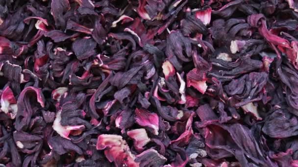 Seco hibisco flores chá rotação textura fundo de sudanês rosa, karkade — Vídeo de Stock