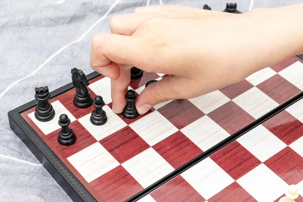 Hand of a child playing chess close up, board games and entertainment concept — Stock Photo, Image