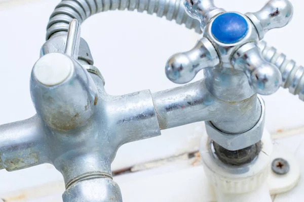 Detail of faucet with limescale or lime scale on it, dirty calcified and rusty shower mixer tap, close up