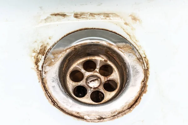 Sucio fregadero de malla de drenaje, agujero con escala de cal o escala de cal y óxido en él de cerca, sucio lavabo baño oxidado — Foto de Stock