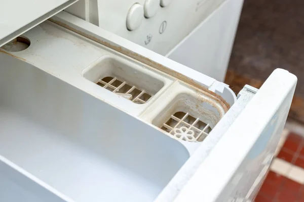 Smutsiga mögliga tvättmaskin tvättmedel och tyg balsam dispenser låda fack nära. Mögel, rost och kalk i tvättmaskin bricka. Regelbundet underhåll av hushållsapparater — Stockfoto