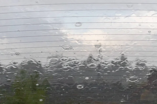 Βροχή σταγόνες στο γυαλί του αυτοκινήτου σε βροχερή μέρα, το καλοκαίρι έχει τελειώσει και φθινοπωρινοί καταιγίδες και κακοκαιρία έρχεται — Φωτογραφία Αρχείου