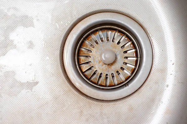 Old rusty calcified drain hole in the kitchen sink with limescale and scurf scum, copy space — Stock Photo, Image