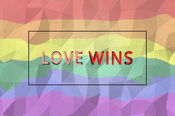 Digitally generated sign with tag love wins on lgbt rainbow colored background