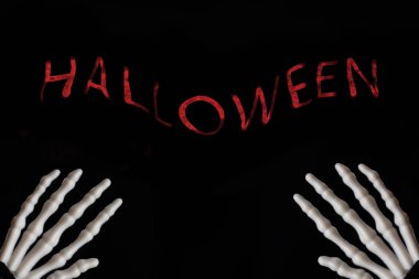 Cadılar Bayramı işareti, ölüm ve mistery kavramı ile siyah arka plan üzerinde iskelet eller