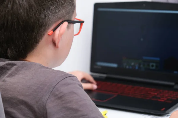 stock image A boy playing online computer game, he is immersed in atmosphere of virtual reality