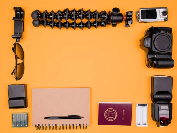 Flatlay accesories of a travel blogger on pastel orange background — Stock Photo, Image