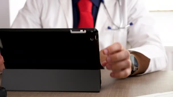 Close up doctor hands typing and browsing on digital tablet PC — Stock Video