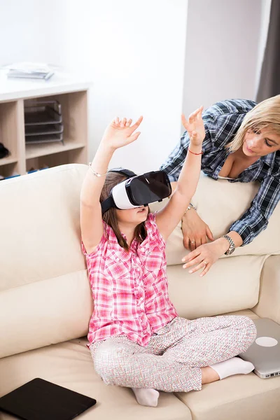 Happy kid wearing a virtual reality headset and plays games