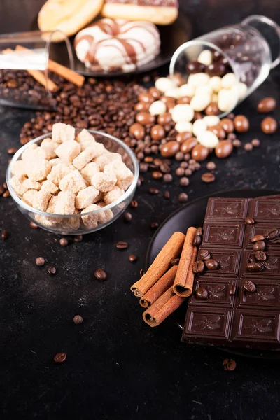 Chocolate tablets next to cinnamon rolls and other sweets and candies