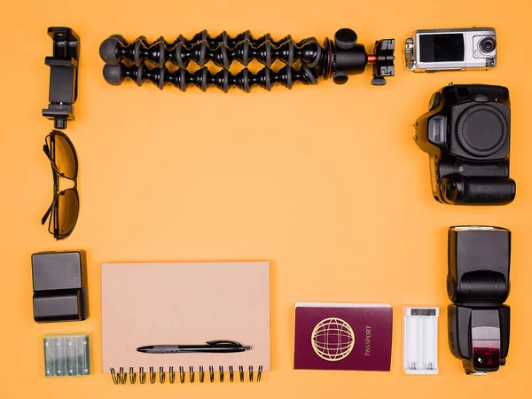 Flatlay accesories of a travel blogger on pastel orange background — Stock Photo, Image