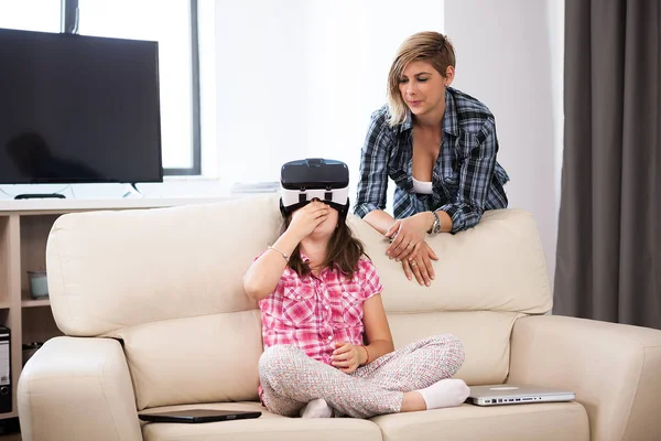 Daughter wearing a VR virtual reality headset on her head