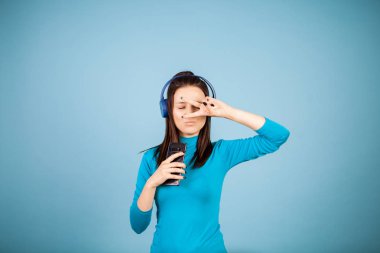 Sevimli genç kadının telefonunu dans ederken şarkı