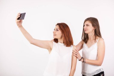 Bir selfie alarak iki güzel genç bir kadın portresi kapatın