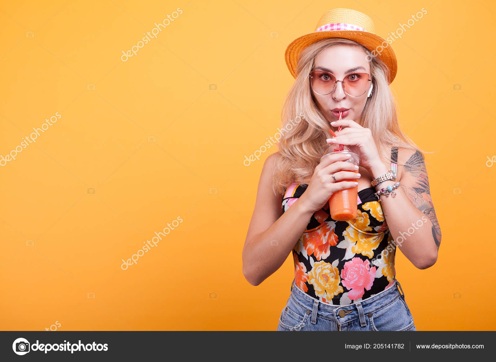 Young Woman With Blonde Hair Drinking Orange Juice With