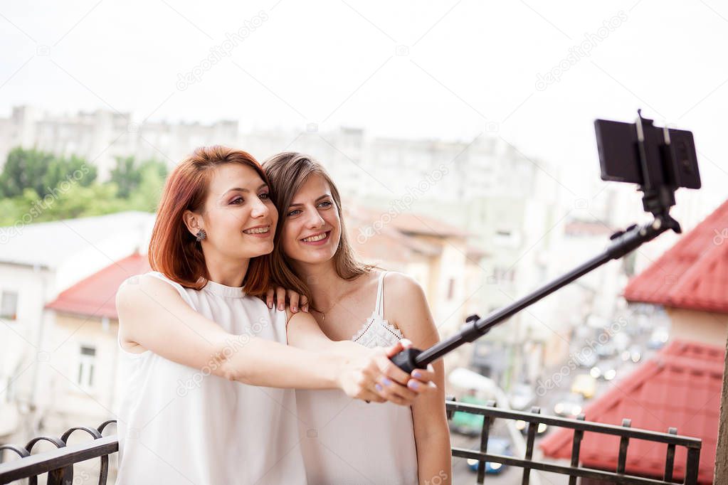 Happy and positive female friends taking a selfie