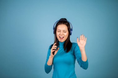 Sevimli genç kadının telefonunu dans ederken şarkı