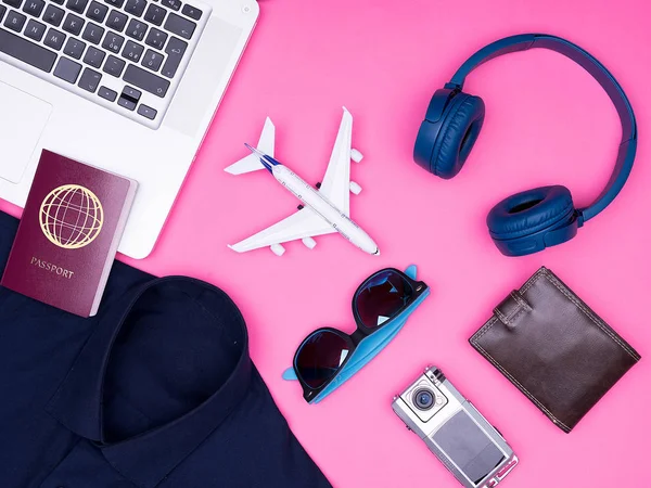 flat lay top view of traveler photographer accessories on pink background