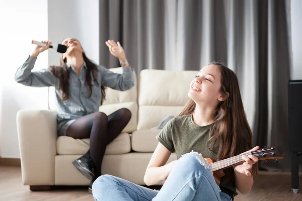 Two sisters having fun in the living room