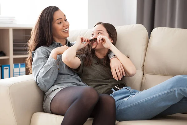 Younger and oldest sisters laughing and having fun