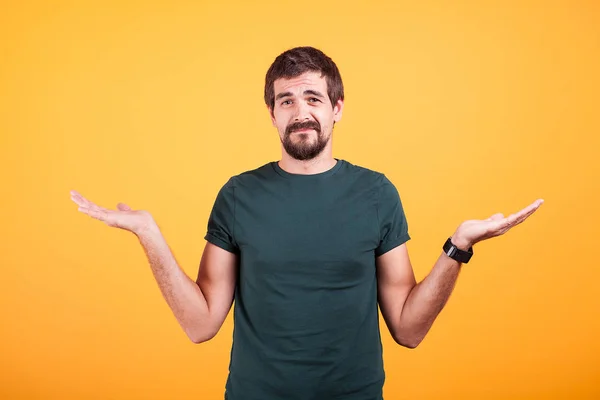 Man with his hands up showing the I do not know sign