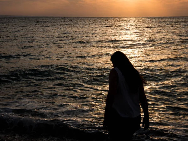 Femeia se relaxează la plajă în timpul apusului de soare frumos . — Fotografie, imagine de stoc