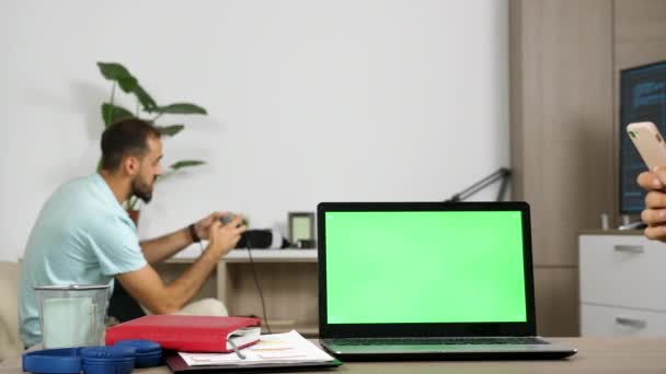 Ordenador portátil con pantalla verde en la mesa de la sala de estar — Vídeos de Stock