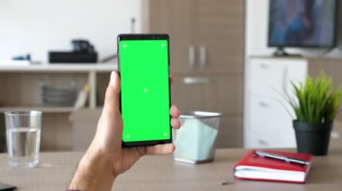Adam yeşil ekran renk ile modern bir akıllı telefon kadar alay tutar
