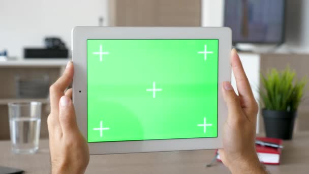 Man holding a big digital talbet PC with green screen chroma mock-up in horizontal mode — Stock Video