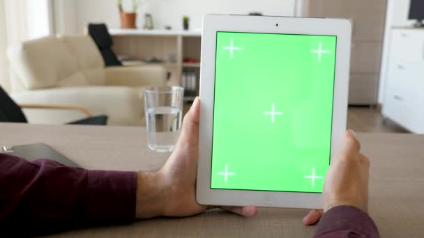 Mantenimento di un tablet digitale in posizione verticale con schermo verde cromato mock up — Video Stock