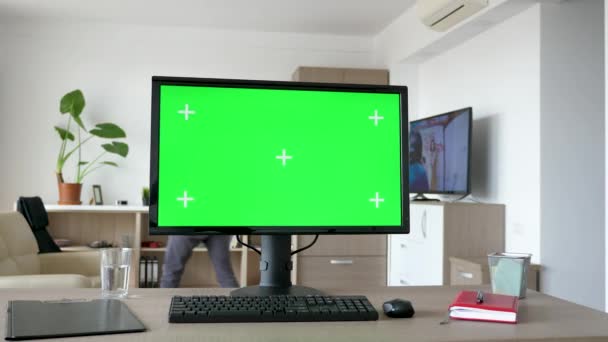 Персональный компьютер с большим зеленым экраном на столе — стоковое видео
