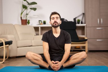 Genç adam onun oturma odasında pratik yoga