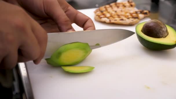 Chief cutting an avocado on board — Stock Video
