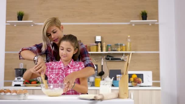 Vacker mor och unga dotter matlagning tillsammans vid köket — Stockvideo