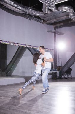 Büyük salonda dans çekici genç bir çift. Spor ve tutku