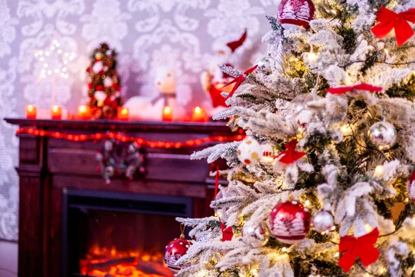 A traditional fireplace with lots of candles and christmas tree. — Stock Photo, Image