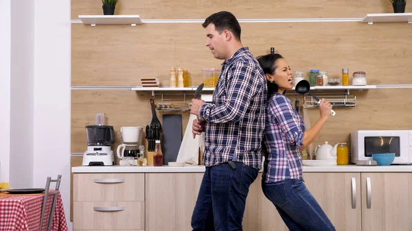 Couple having fun while cooking in their home — Stock Photo, Image