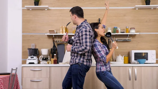 Couple having fun while cooking in their home — Stock Photo, Image