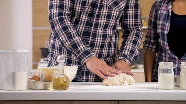 Young man baking something sweet for him and his wife