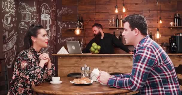 Gorgeous couple enjoying their coffee in hipster coffee shop — Stock Video