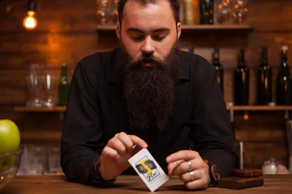 Barman hipster barbudo jugando con sus cartas de truco . —  Fotos de Stock