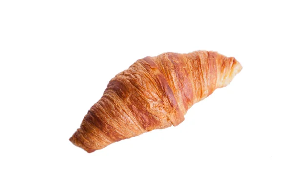 Croissant fresco e saboroso sobre fundo branco — Fotografia de Stock