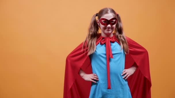 Fille dans un costume de super-héros souriant à la caméra — Video